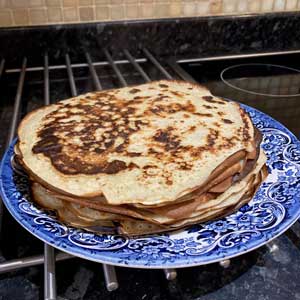 10 steaming freshly cooked banana pancakes