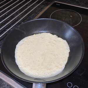 pancake mixture spread in pan