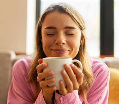 Lady content with a mug of hot bone broth