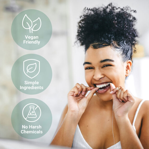 A woman using Ola Botanicals® Peppermint Dental Floss to clean her teeth with